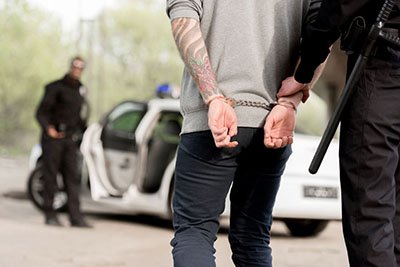 Man being arrested, hiring a drug sales attorney in Huntington Beach, CA