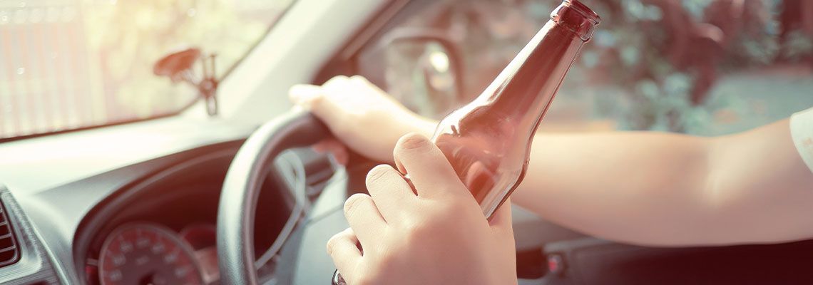Man drink beer while driving car