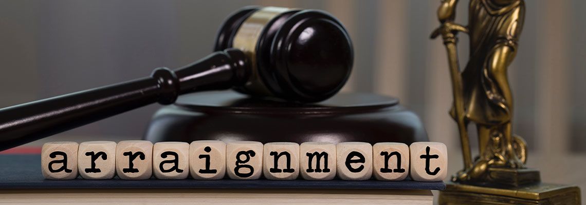 Word ARRAIGNMENT composed of wooden dices