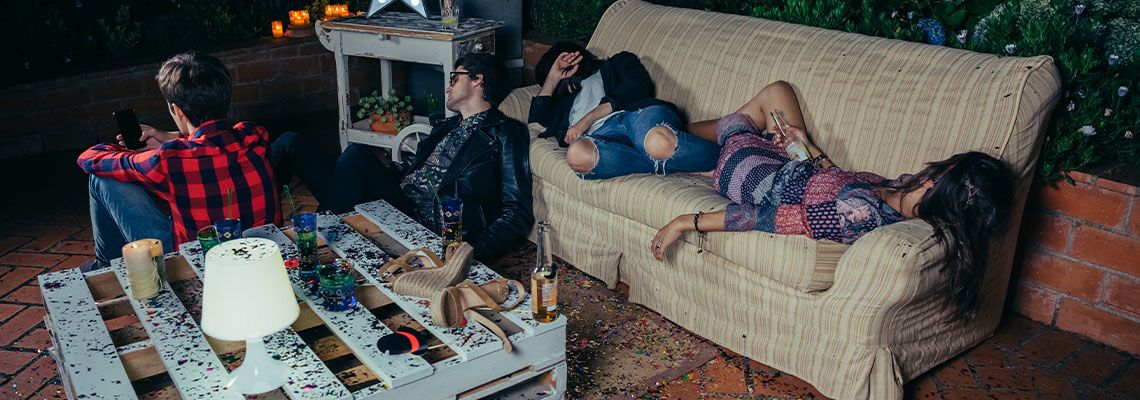 Group of friends sleeping in sofa outdoors after party
