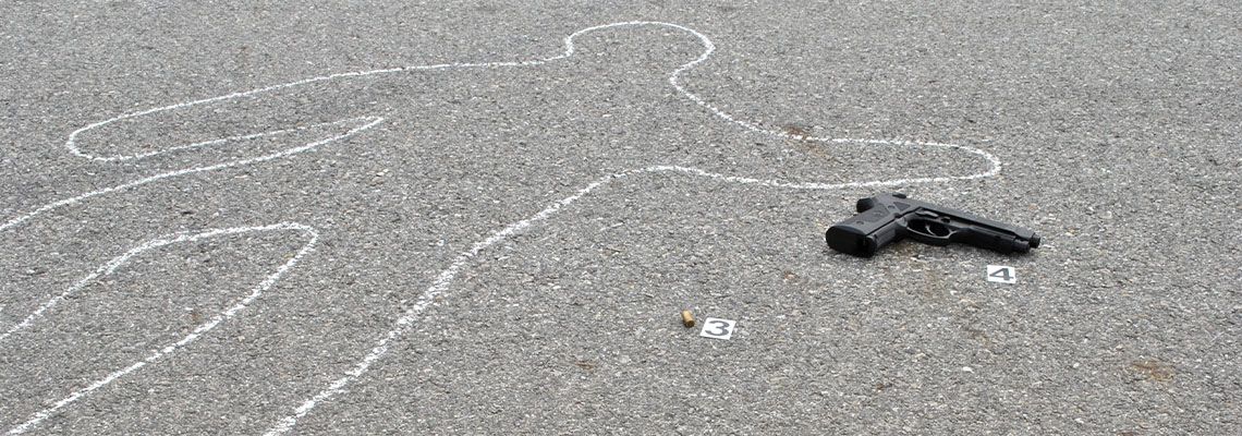 Chalk outline of murder victim next to evidence in the street