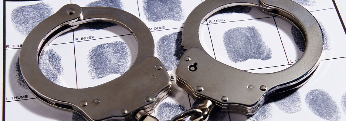 Handcuffs laying on top of fingerprint chart