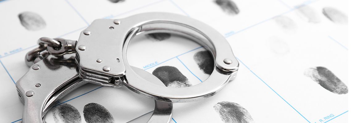 Criminal fingerprint record and handcuffs