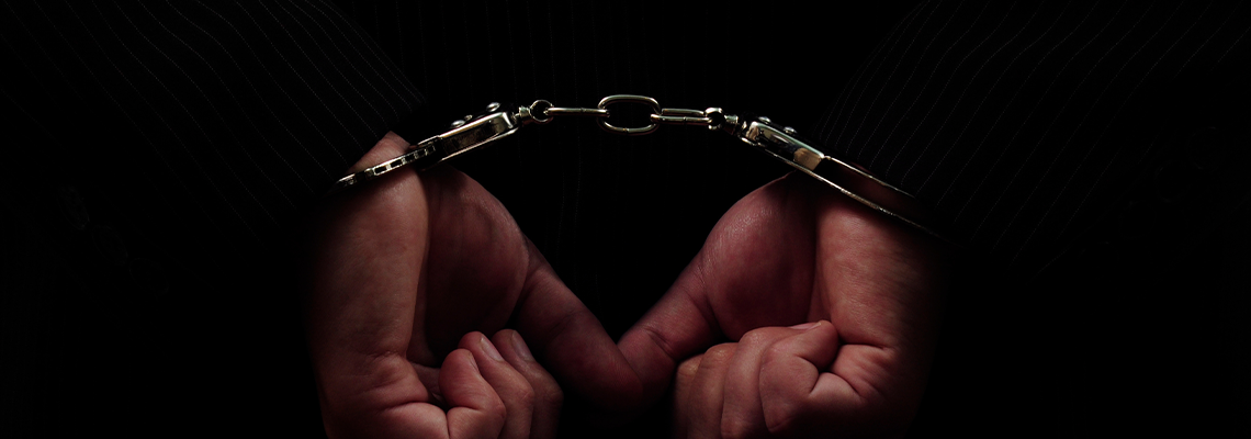 Person's hands in handcuff